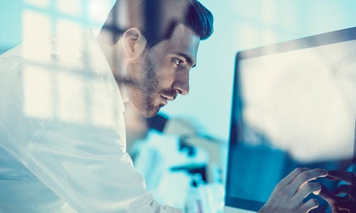 A pharmacy tech using a computer<br>  