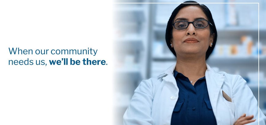 Pharmacist in leadership stance next to the words &quot;When Our Community Needs Us, We'll Be There&quot;.