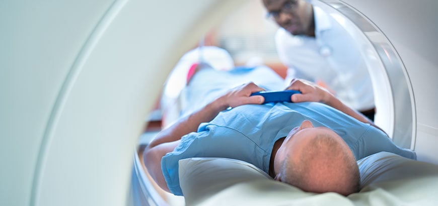 A man lying on a table in an MRI machine