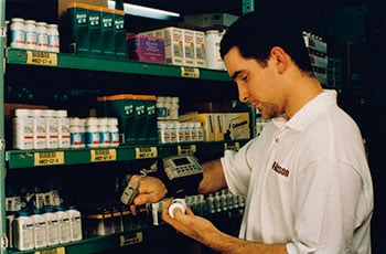 A worker scanning medications with an Acumax wrist mounted scanner