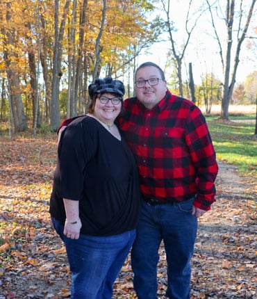 Malisa Peters and her husband stand on a forest path