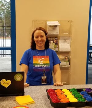 Debra Randels at an OPEN event, serving rainbow cupcakes