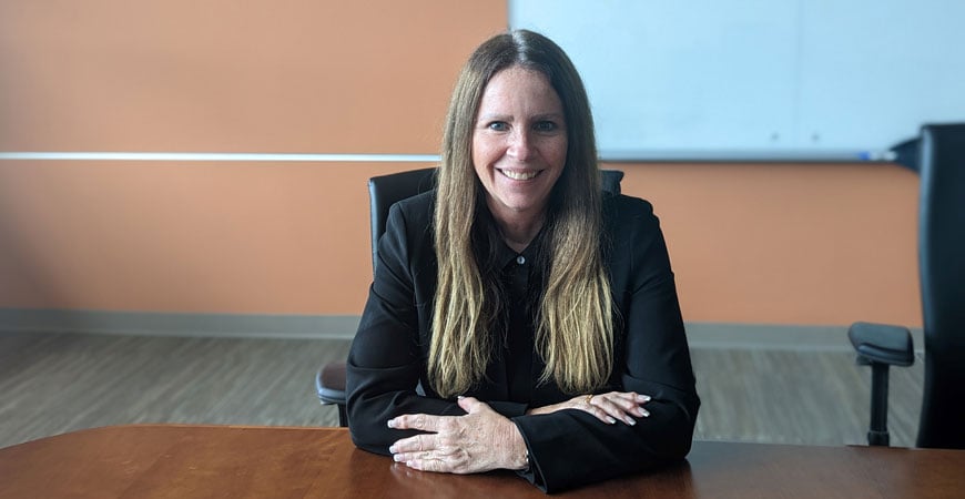 Susan Dean sitting at her desk.